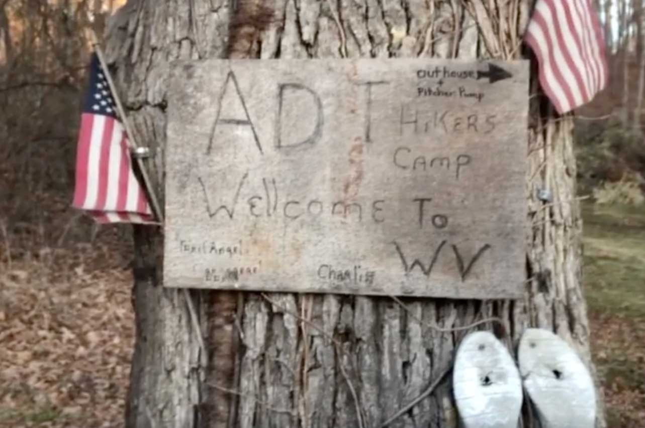 Sign and shoes at "Trail Angel Chuck's (formerly Trail Angel Charlie's) hiker camp near Fort Ashby, WV