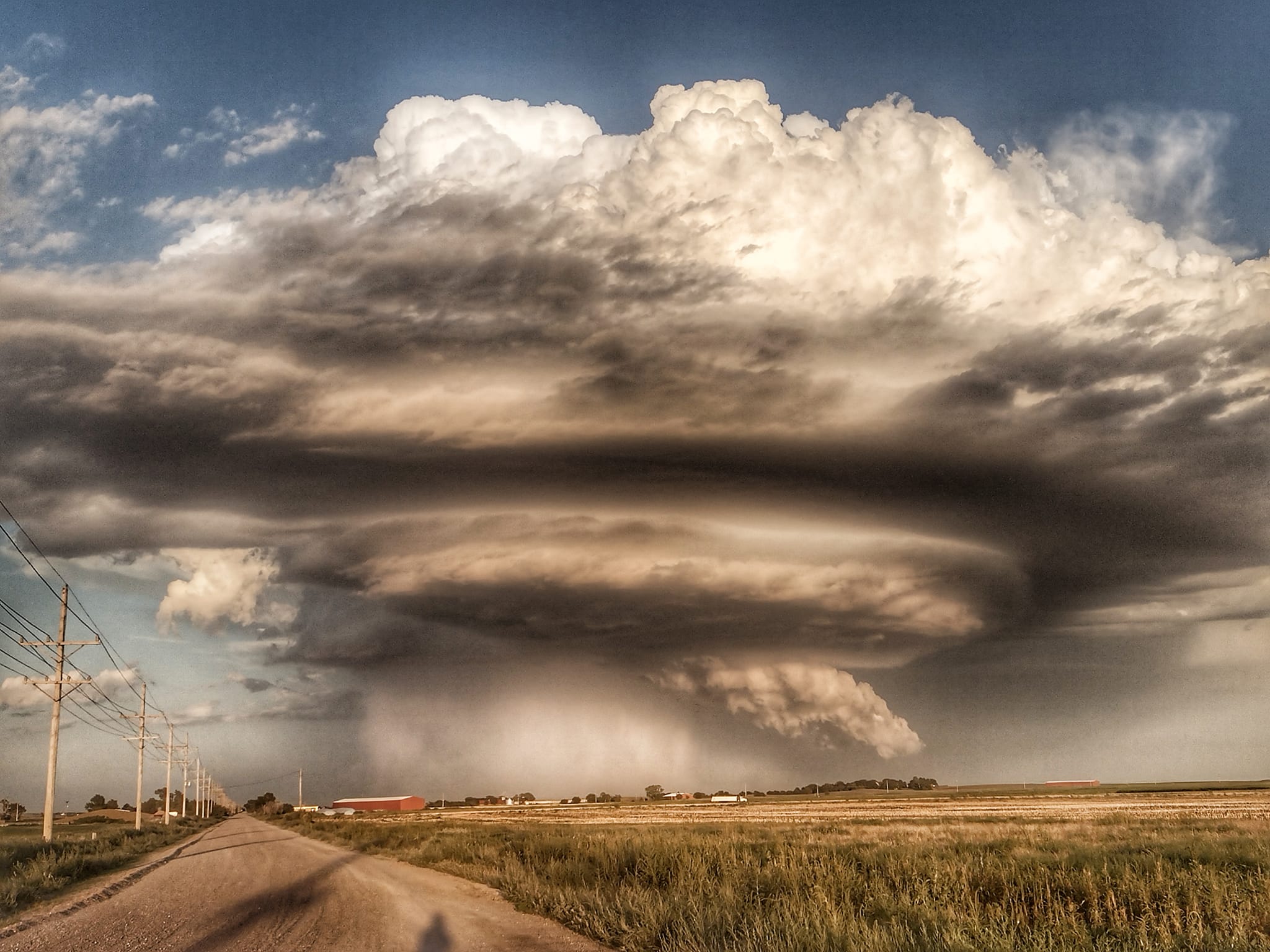 Huge storm cloud forming over a Kansas field.